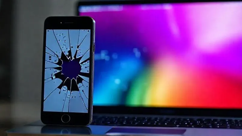 A photorealistic image of a broken, pixelated digital banner on a smartphone screen, contrasting with a perfectly optimized, sharp, and responsive banner on a laptop screen, emphasizing the importance of responsive design. Cinematic lighting, 8K, shot on a high-end DSLR.