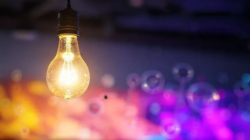 A photorealistic image of a lightbulb glowing brightly above a series of interconnected thought bubbles, symbolizing innovative ideas for student re-engagement. The background is a vibrant, abstract digital learning space. photorealistic, professional photography, 8K, cinematic lighting, sharp focus, depth of field, shot on a high-end DSLR.