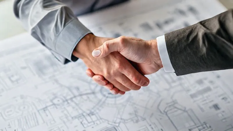 A photorealistic image showing two hands shaking over a complex digital blueprint, symbolizing partnership and legal agreement in a scalable online business. Professional photography, 8K, cinematic lighting, sharp focus on the hands and blueprint, depth of field.